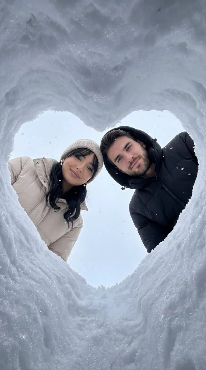 Romantic Couple Winter Portrait in Snow Heart Shape